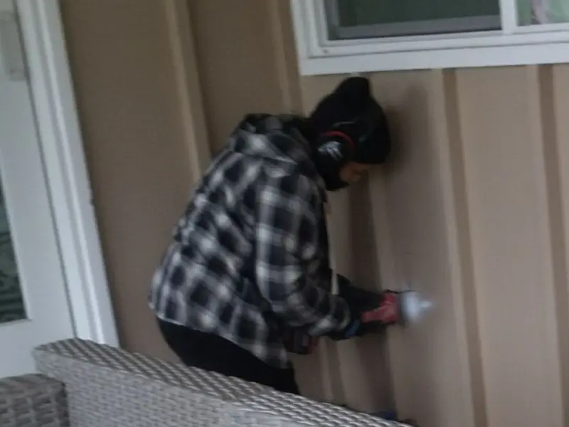 Professional electrician installing an exterior outlet in Canby